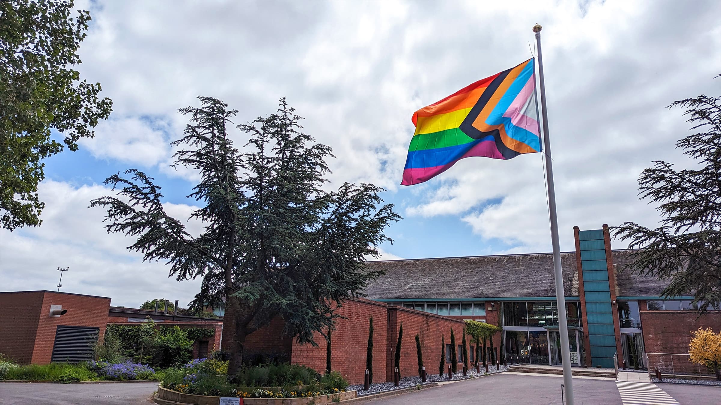LGBTQ+ flag flying high outside Rare entrance